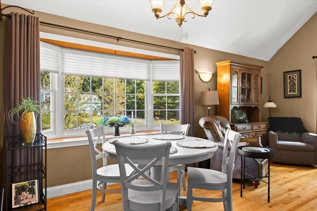 125 Independence Avenue Hanson, MA 02341 - Photo 27 of 42 a dining room with furniture a chandelier and wooden floor