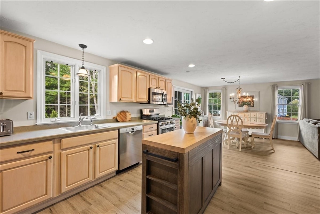 125 Independence Avenue Hanson, MA 02341 - Photo 6 of 42 a kitchen with counter top space sink stove and wooden floor