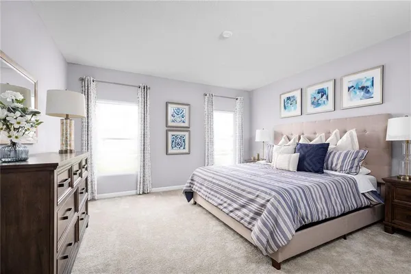 a bedroom with a bed flat screen tv and a window