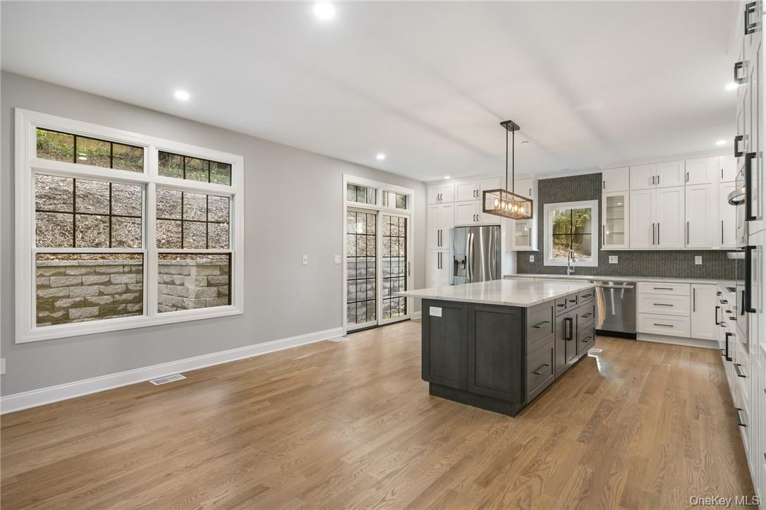14 Shady Road Ardsley, NY 10502 - Photo 13 of 37 a large kitchen with kitchen island a large counter top space a sink stainless steel appliances and cabinets