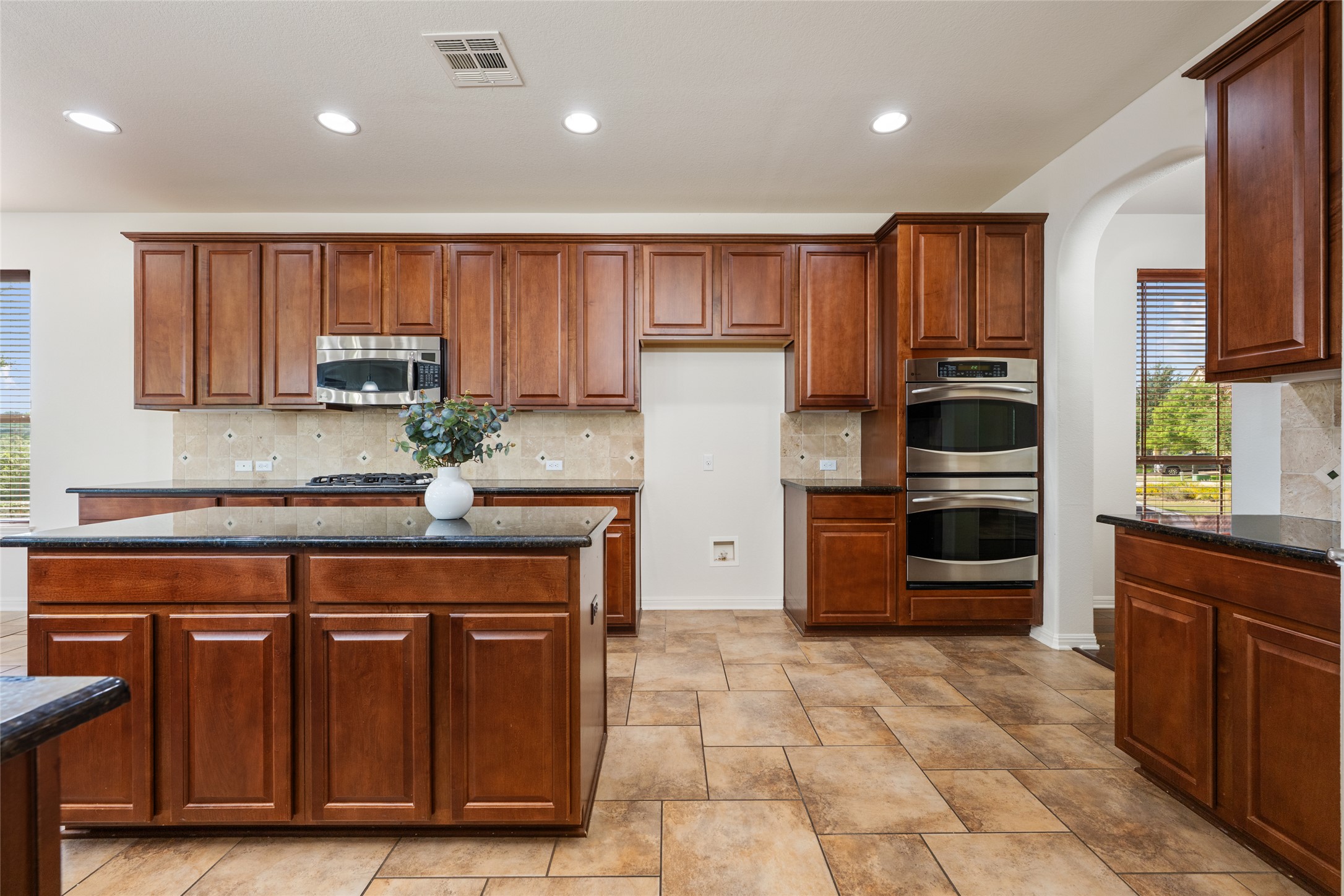 15205 Spillman Ranch Loop Austin, TX 78738 - Photo 17 of 40 Culinary delights await in this spacious kitchen featuring abundant cabinetry and sleek stainless steel appliances.