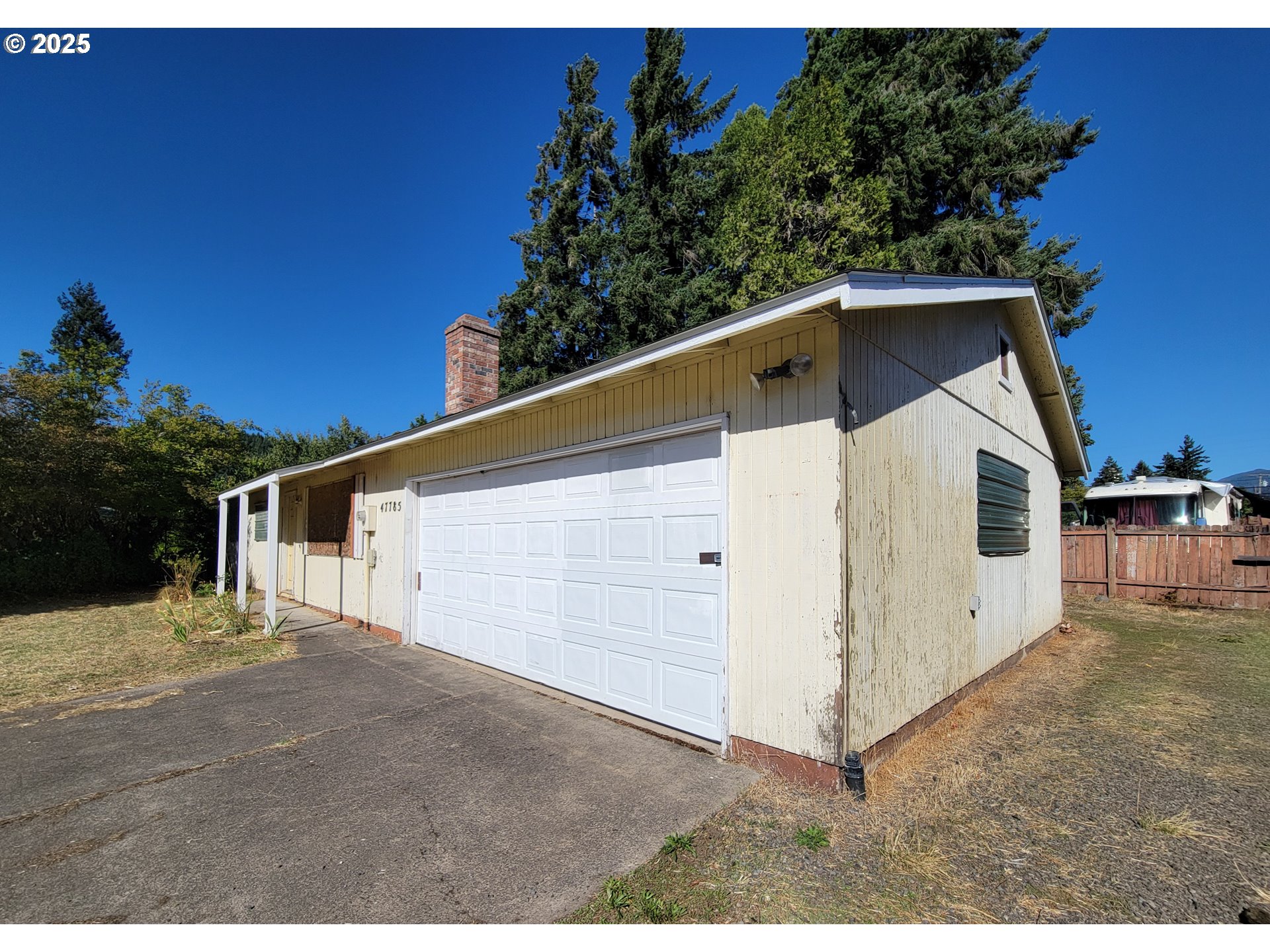 47785 Chubb Street Oakridge, OR 97463 - Photo 3 of 24 a view of a white house with a yard