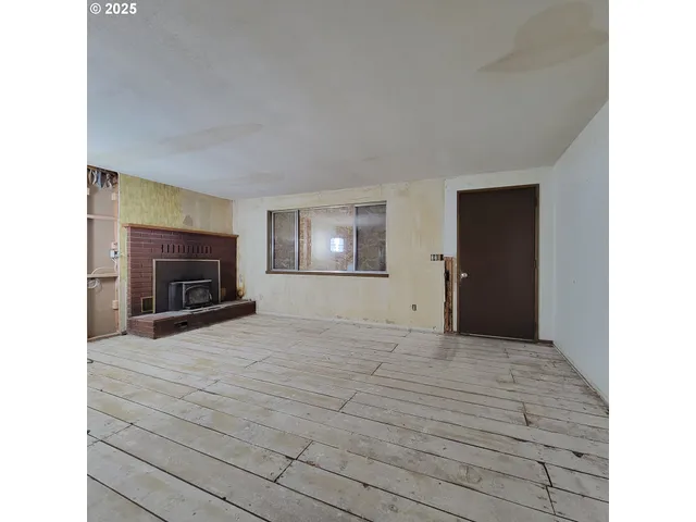 a view of empty room with furniture and a fireplace