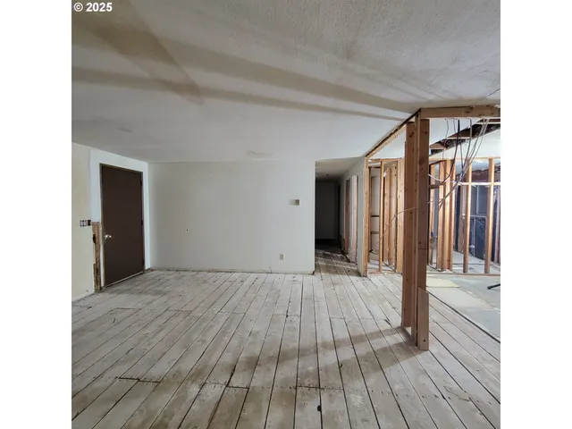 a view of a room with wooden floor