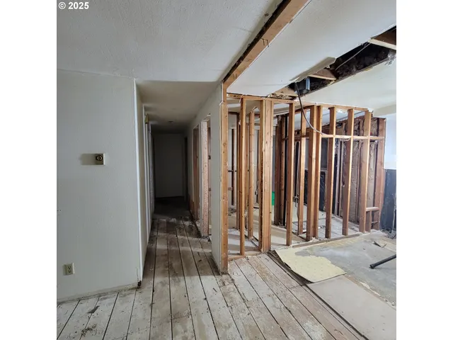a view of hallway with wooden floor