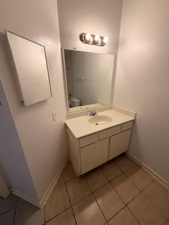 a bathroom with a sink and mirror