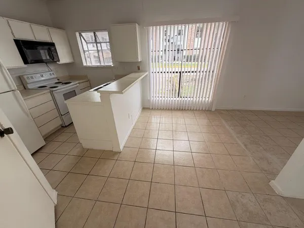 a view of a kitchen with an empty space and a window