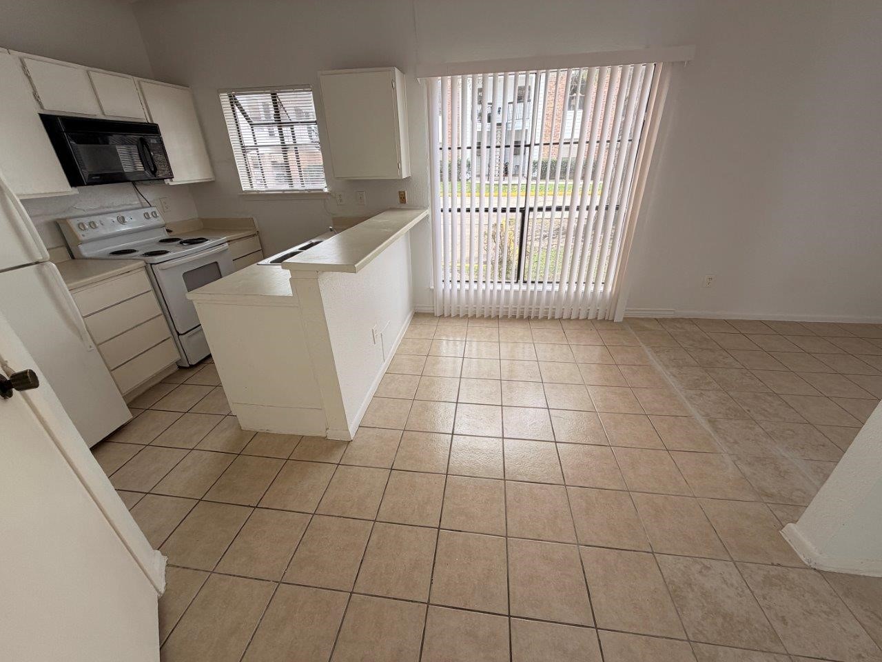 7901 Cambridge Street, Unit 25 Houston, TX 77054 - Photo 3 of 18 a view of a kitchen with an empty space and a window