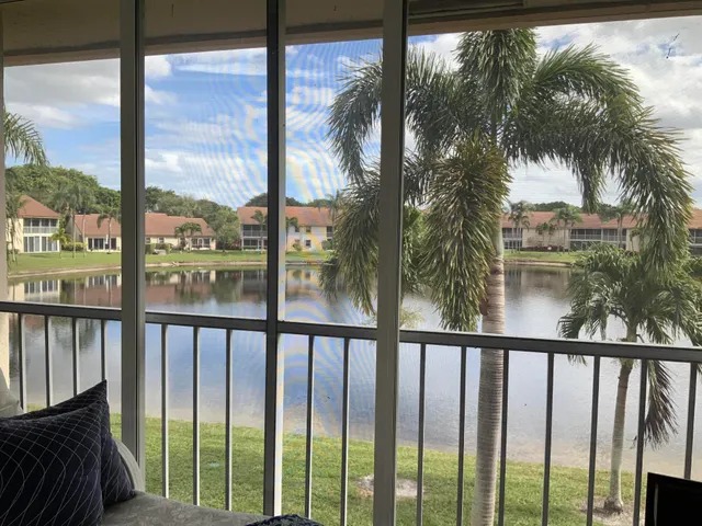 a view of a glass door with a trees from a window