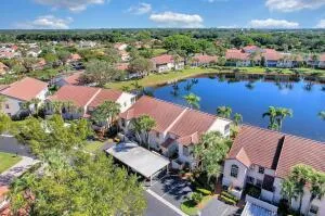 an aerial view of residential houses with outdoor space and lake view