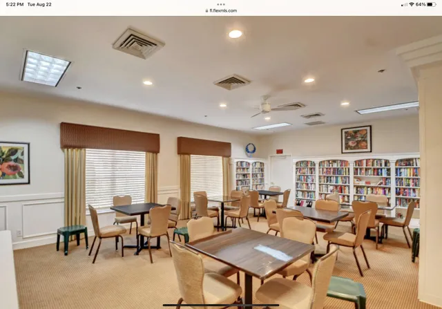 a living room with lots of furniture and a large window