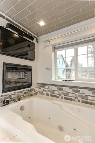a bathroom with washing machine and shower