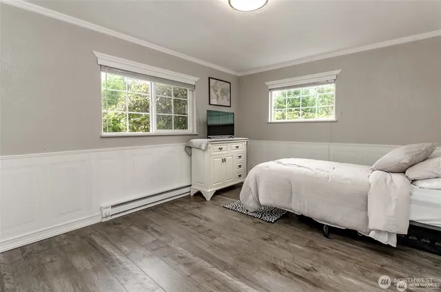 an empty room with wooden floor and a window