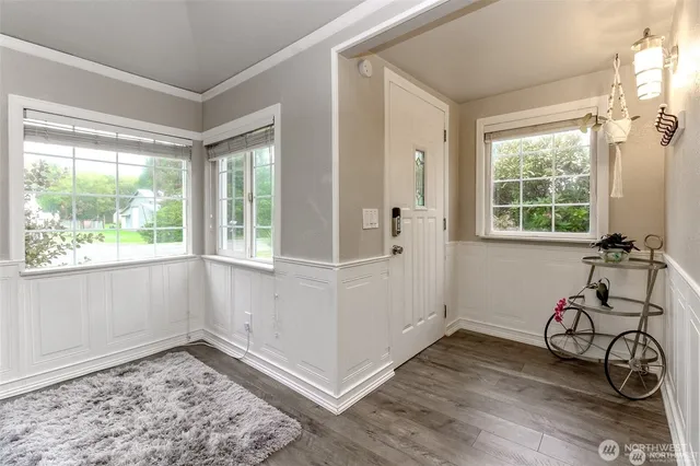 a view of a livingroom with wooden floor and a window