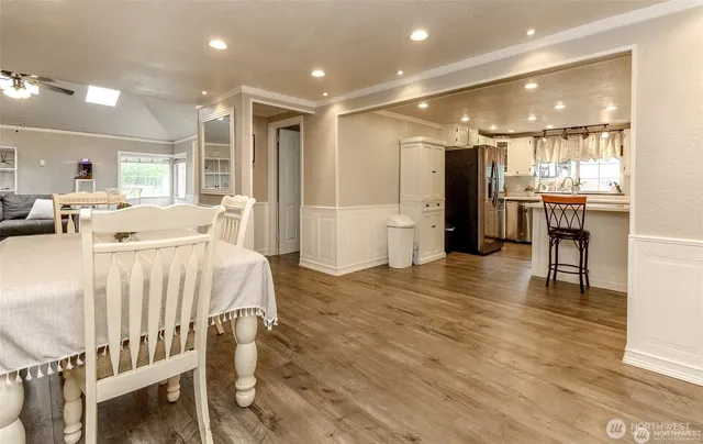a large white kitchen with a large window
