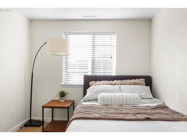 a bedroom with a bed and a window