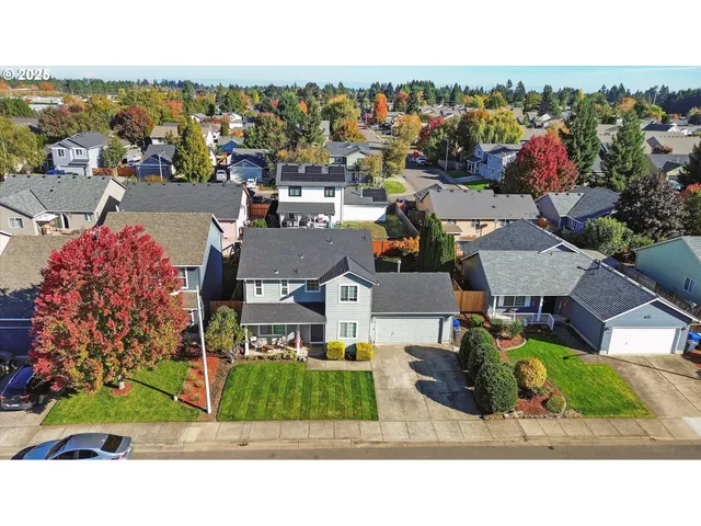a view of a house with a backyard