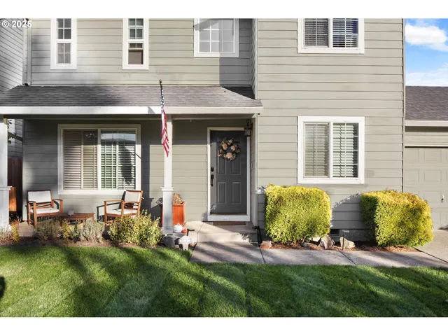 a view of a backyard with table and chairs and potted plants
