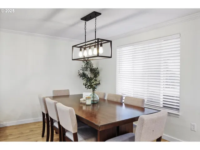 a view of a dining room with a table and chairs