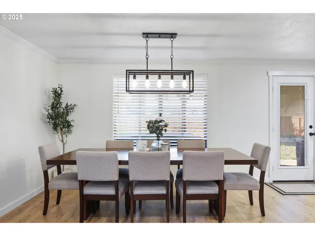a view of a dining room with furniture and window