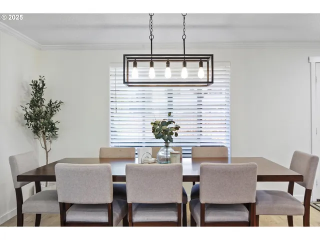 a dining room with furniture and wooden floor
