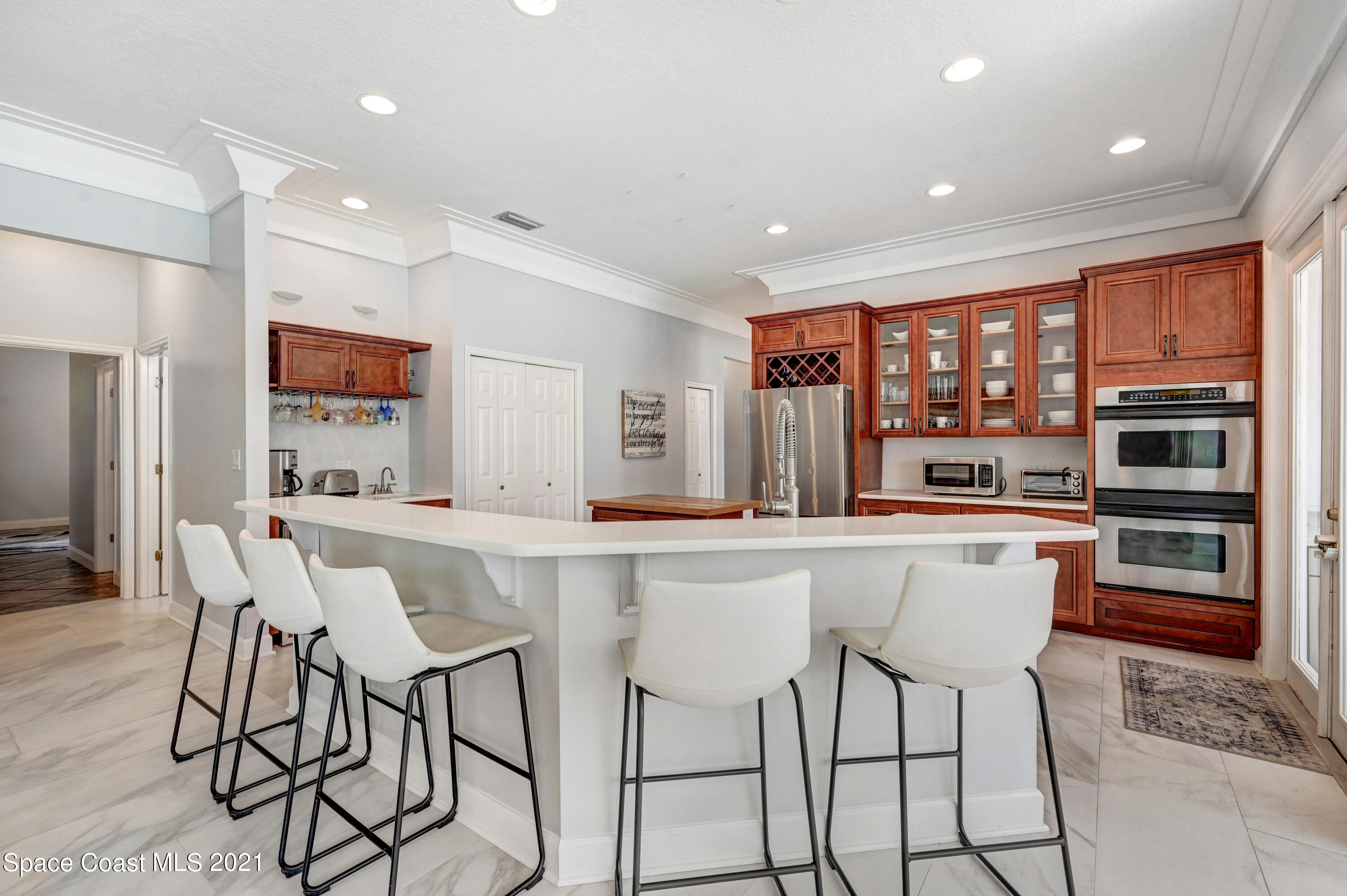 4601 Indian River Drive Cocoa, FL 32927 - Photo 17 of 51 a kitchen with stainless steel appliances a dining table chairs and granite counter tops