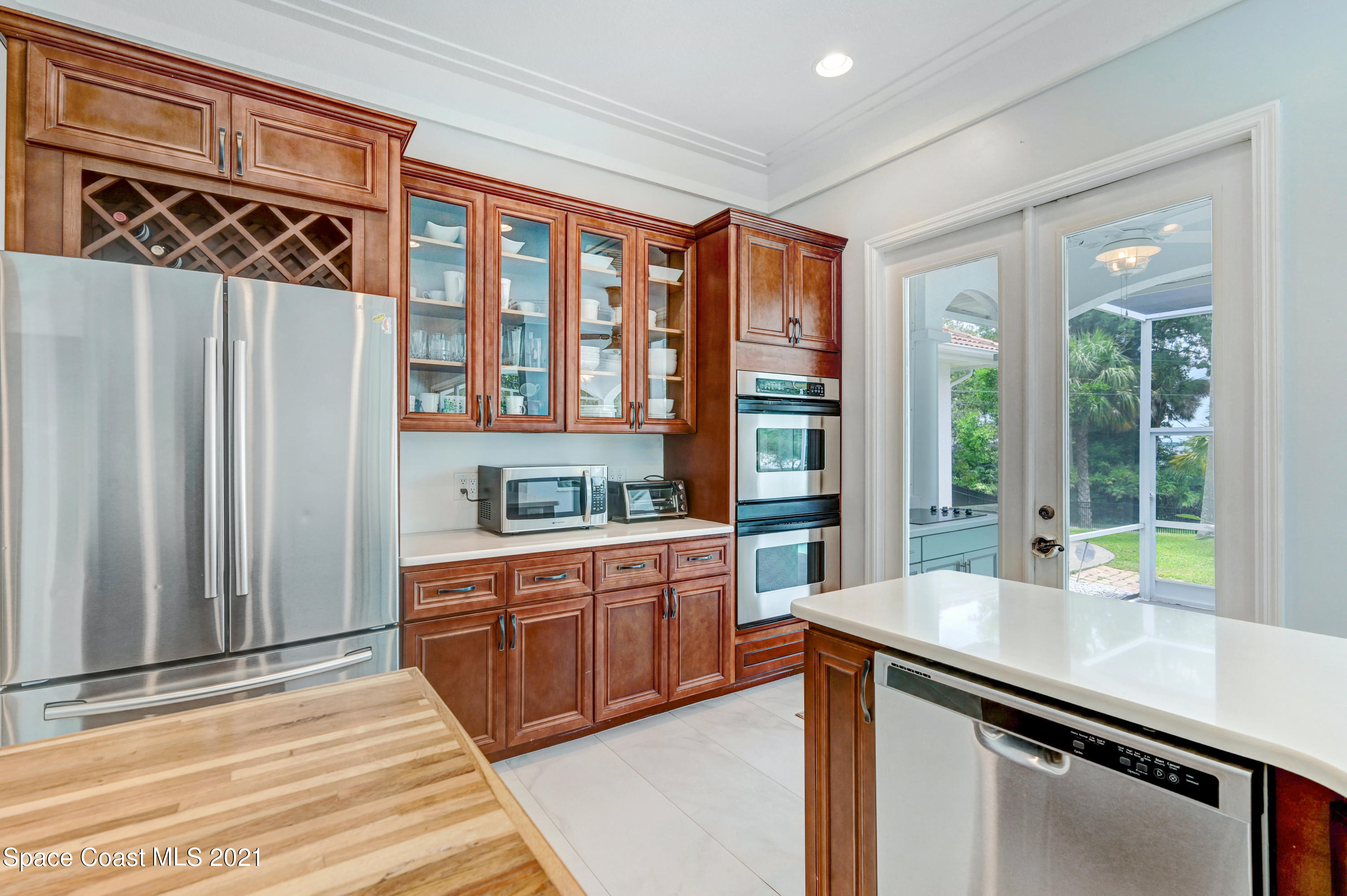 4601 Indian River Drive Cocoa, FL 32927 - Photo 19 of 51 a kitchen with stainless steel appliances granite countertop a sink and a wooden cabinets