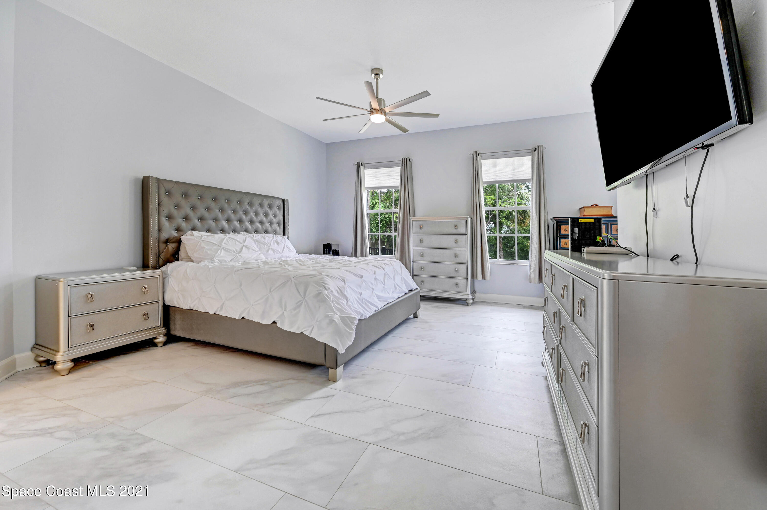 4601 Indian River Drive Cocoa, FL 32927 - Photo 25 of 51 a bedroom with a bed and a flat screen tv