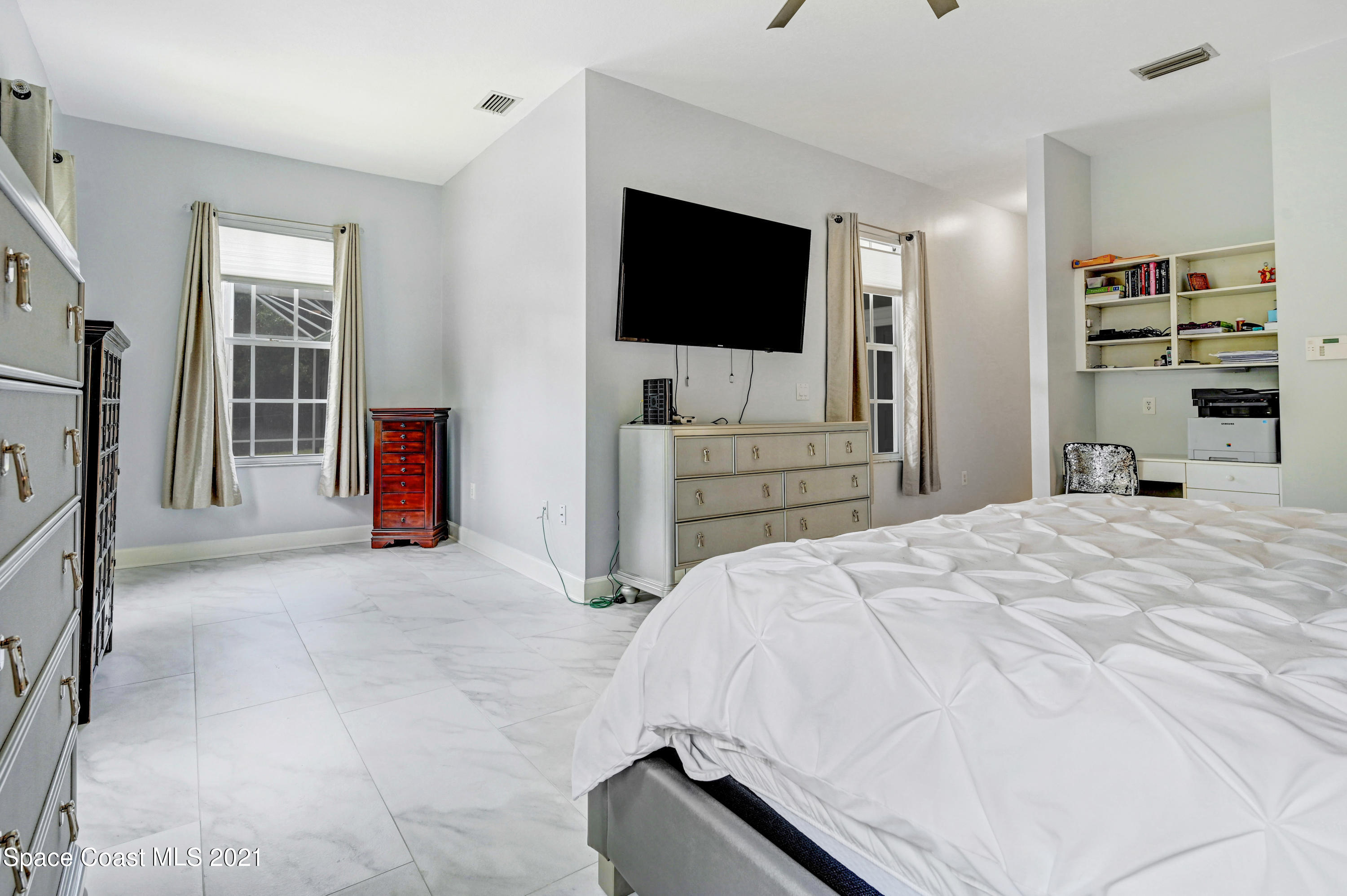 4601 Indian River Drive Cocoa, FL 32927 - Photo 26 of 51 a bedroom with a bed and a flat tv screen in it