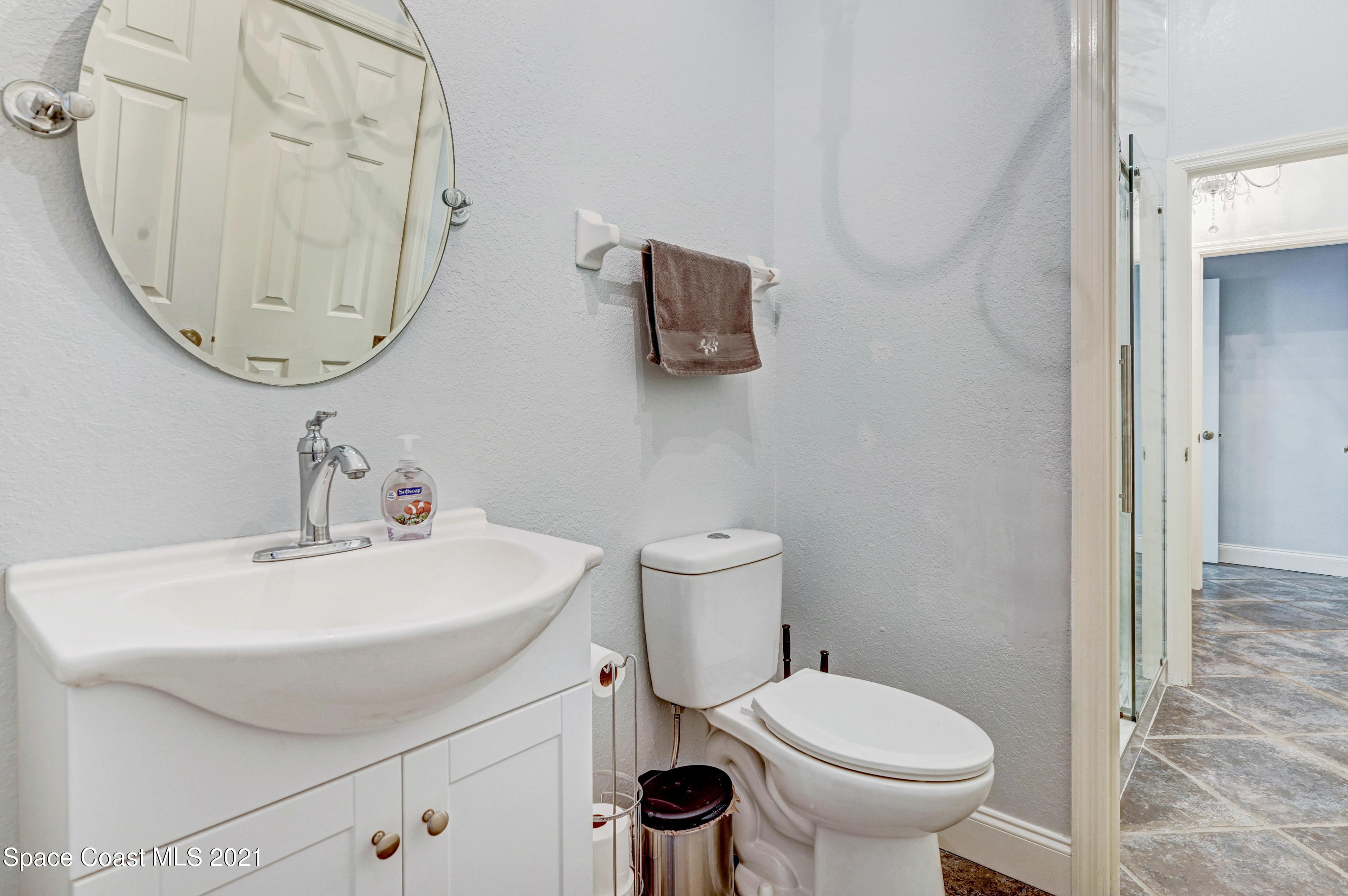4601 Indian River Drive Cocoa, FL 32927 - Photo 31 of 51 a bathroom with a sink a toilet and a mirror