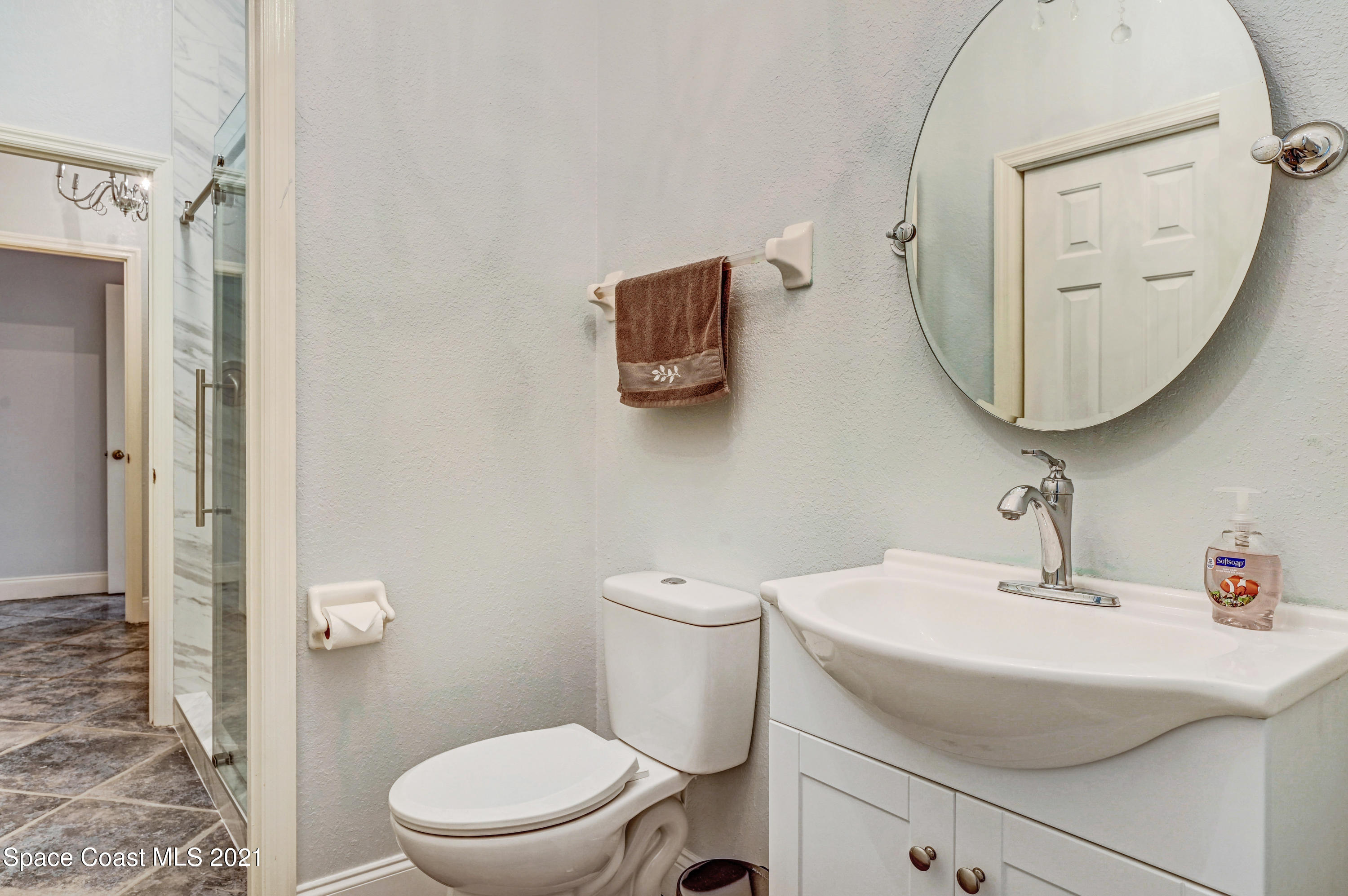 4601 Indian River Drive Cocoa, FL 32927 - Photo 35 of 51 a bathroom with a sink a toilet and a mirror