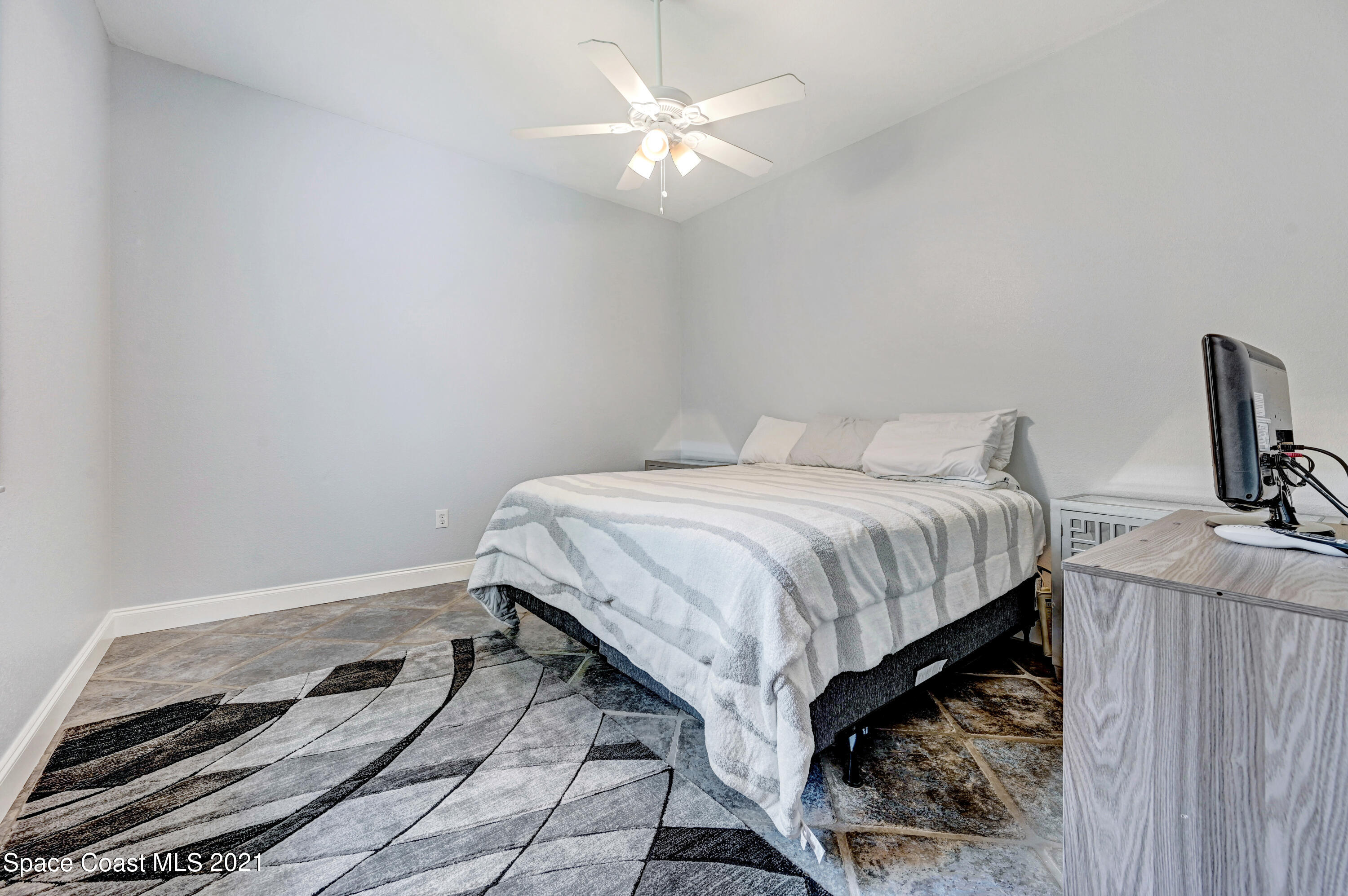 4601 Indian River Drive Cocoa, FL 32927 - Photo 37 of 51 a bedroom with a bed and a chandelier