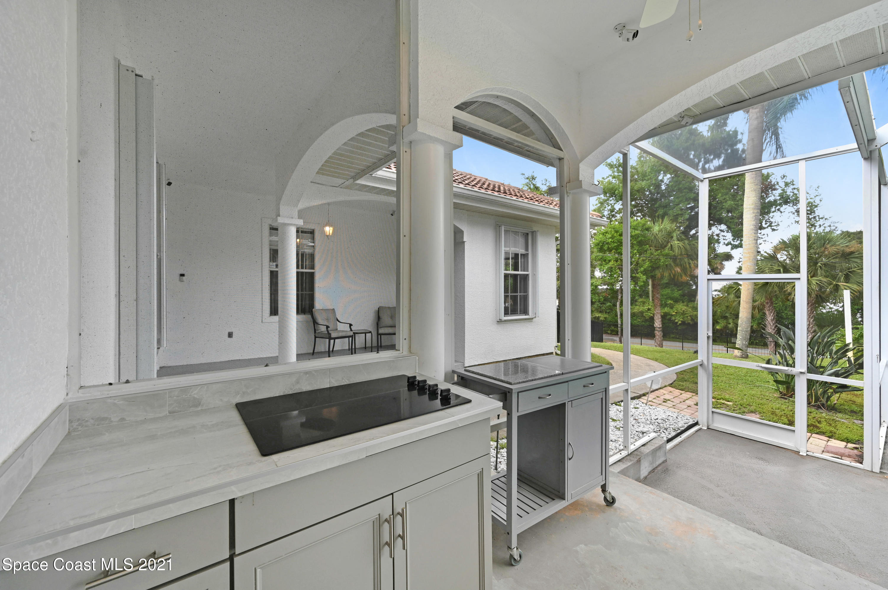 4601 Indian River Drive Cocoa, FL 32927 - Photo 38 of 51 a kitchen with a sink and a stove next to a window