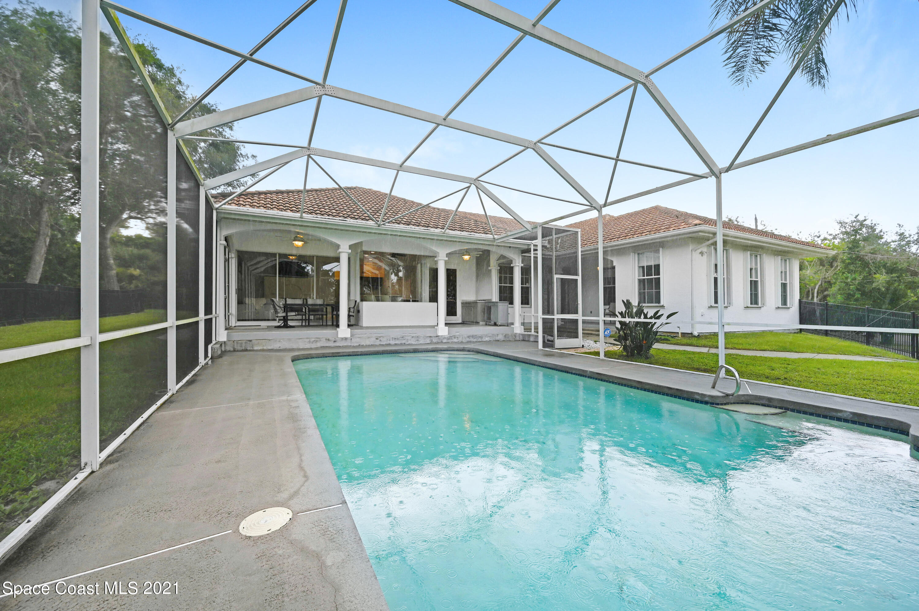 4601 Indian River Drive Cocoa, FL 32927 - Photo 41 of 51 a view of a patio with a table and chairs under an umbrella
