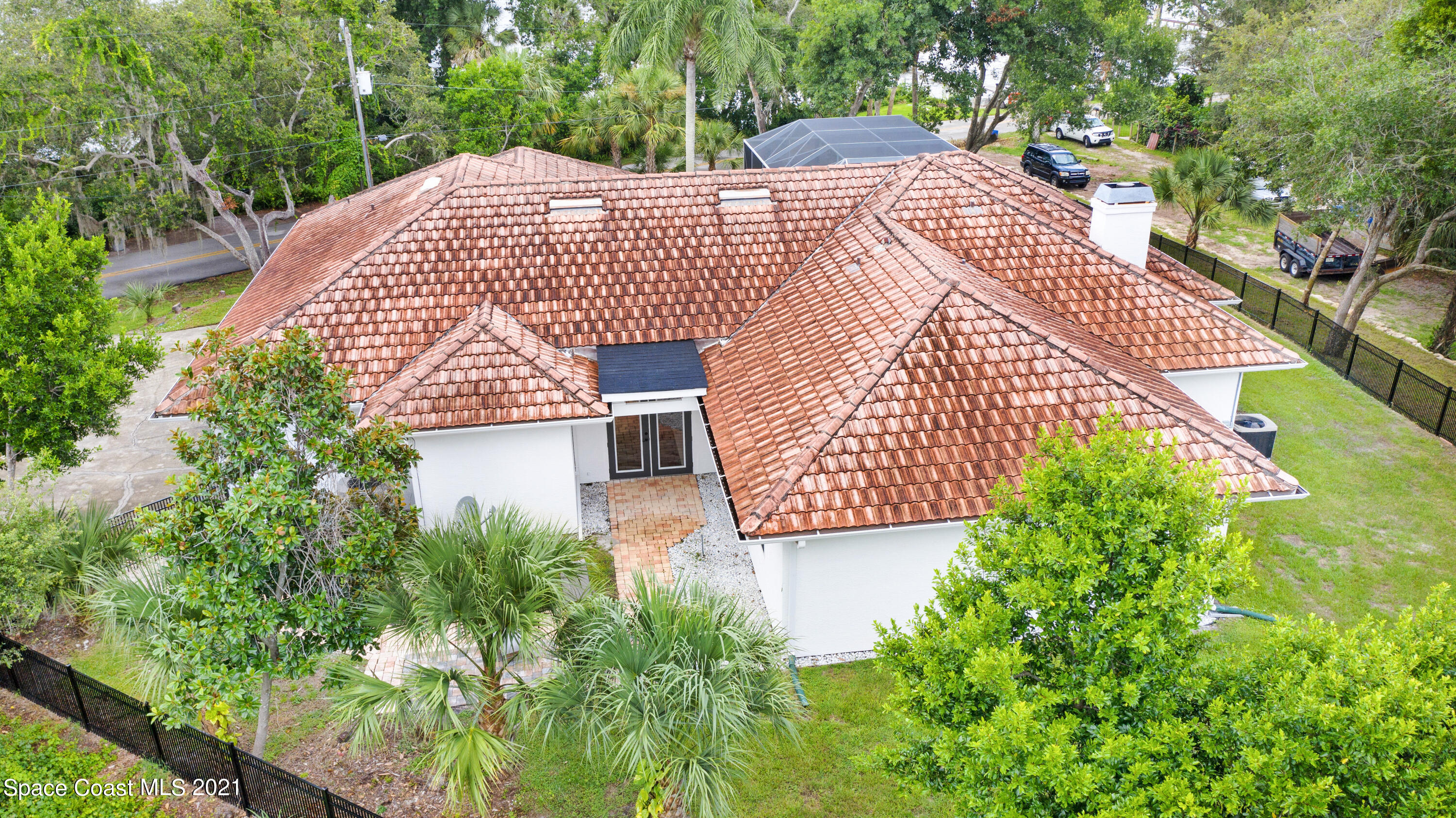 4601 Indian River Drive Cocoa, FL 32927 - Photo 49 of 51 a view of a white house with a yard and potted plants