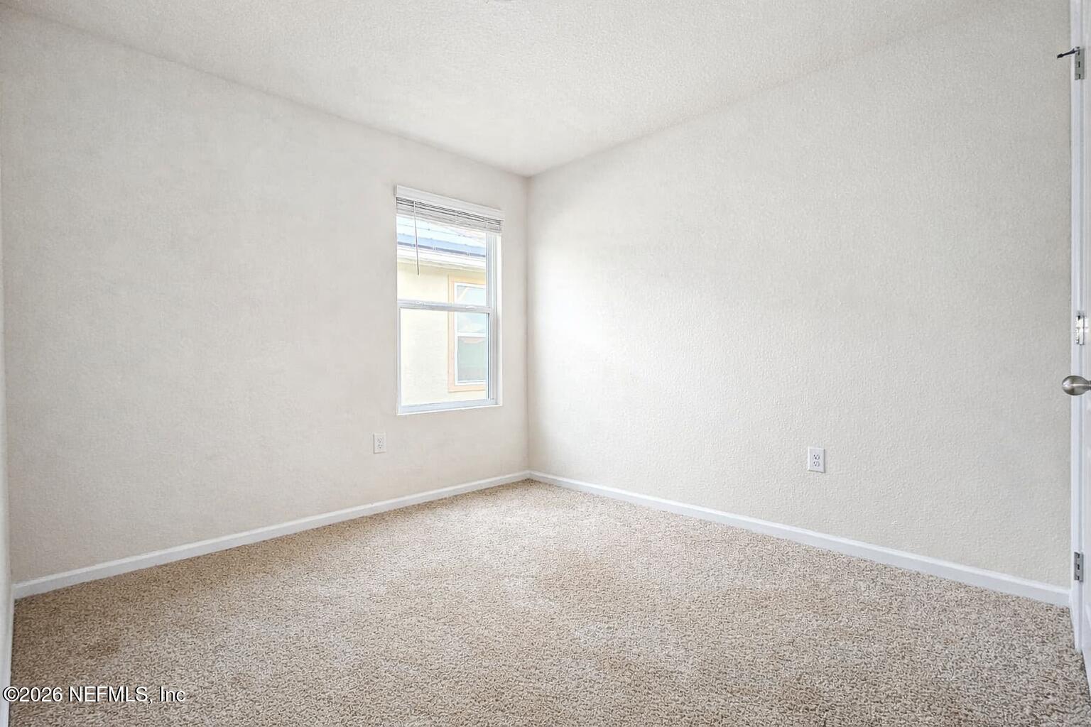 86226 Mainline Road Yulee, FL 32097 - Photo 14 of 22 a view of an empty room with a window