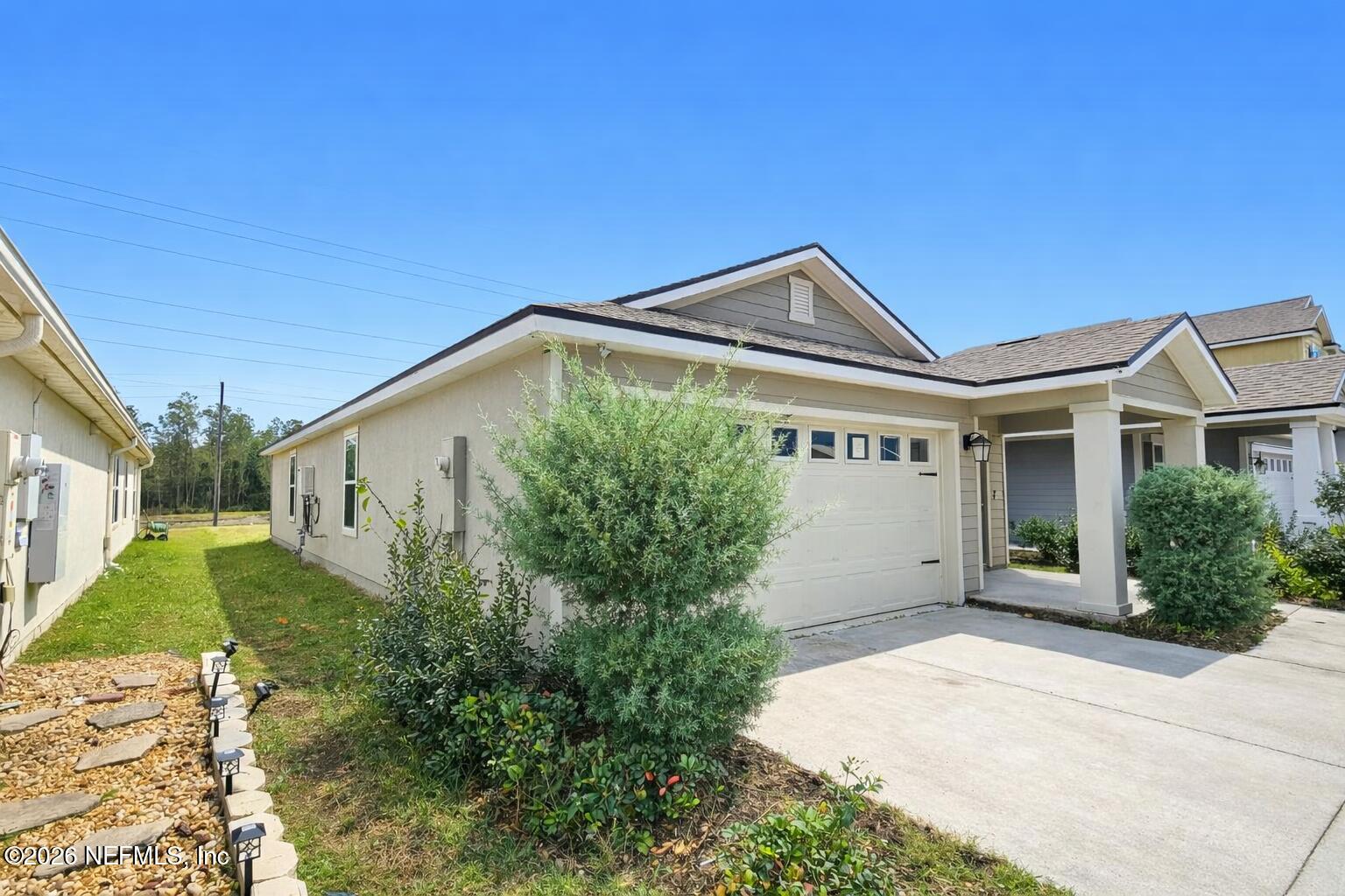 86226 Mainline Road Yulee, FL 32097 - Photo 15 of 22 a front view of a house with garden