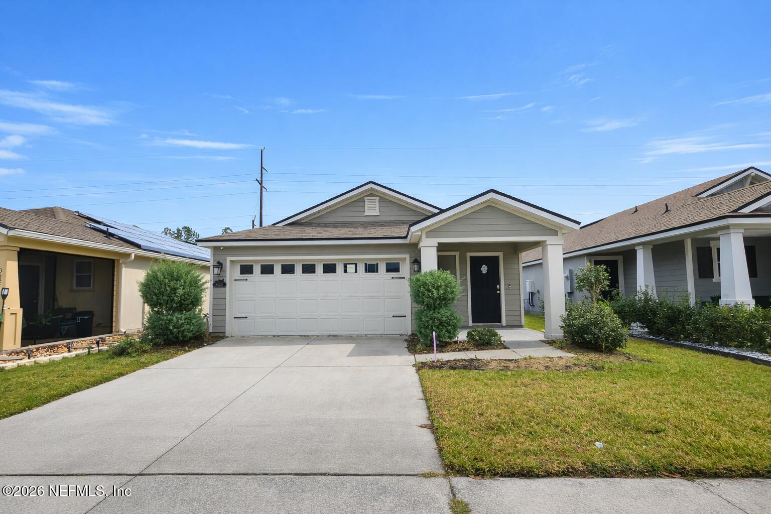 86226 Mainline Road Yulee, FL 32097 - Photo 18 of 22 a view of a house with a yard and potted plants