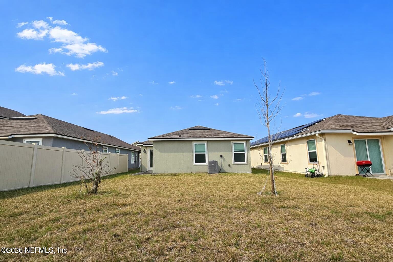 86226 Mainline Road Yulee, FL 32097 - Photo 20 of 22 a white house with a big yard and large tree