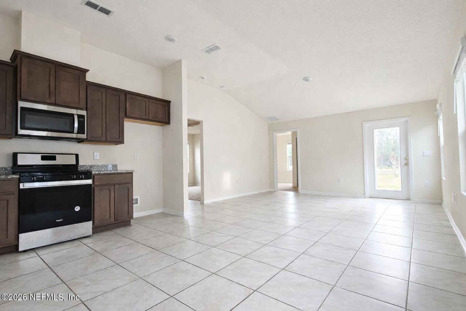 86226 Mainline Road Yulee, FL 32097 - Photo 2 of 22 a kitchen with stainless steel appliances granite countertop a stove and a sink