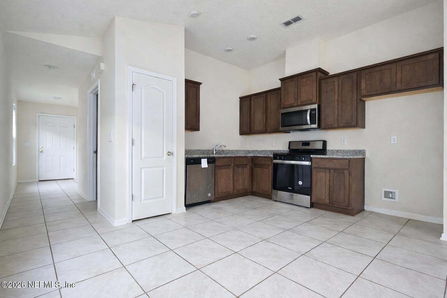 86226 Mainline Road Yulee, FL 32097 - Photo 10 of 22 a kitchen with stainless steel appliances granite countertop a refrigerator and a stove