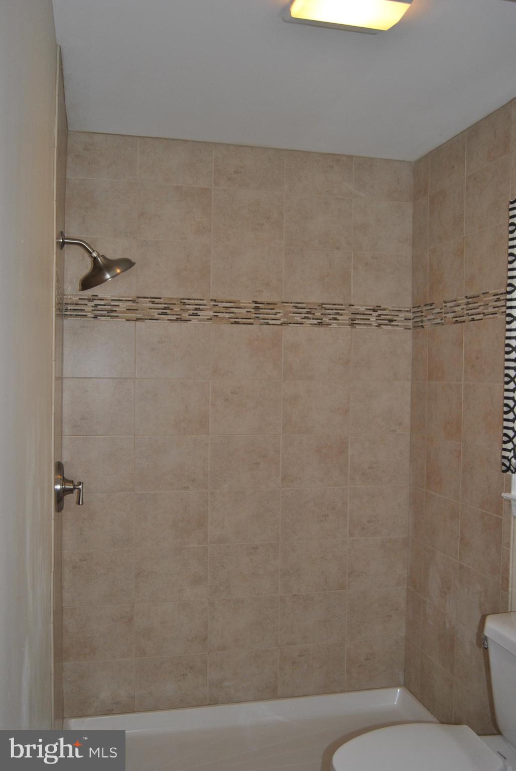 6579 Hemlock Point Road New Market, MD 21774 - Photo 10 of 18 Main level bath has oversized shower & pretty tile