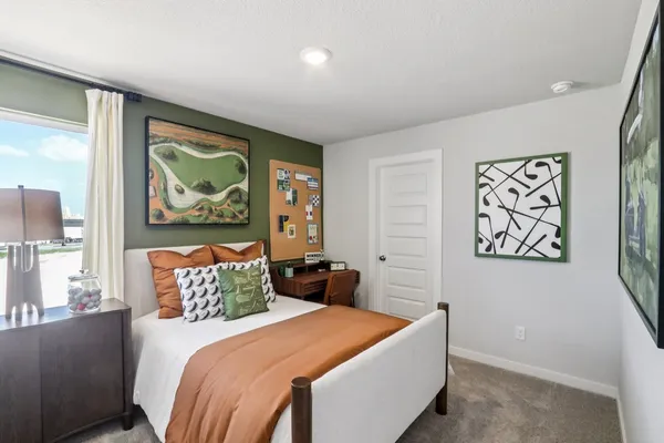 a bedroom with a large bed and a painting on the wall