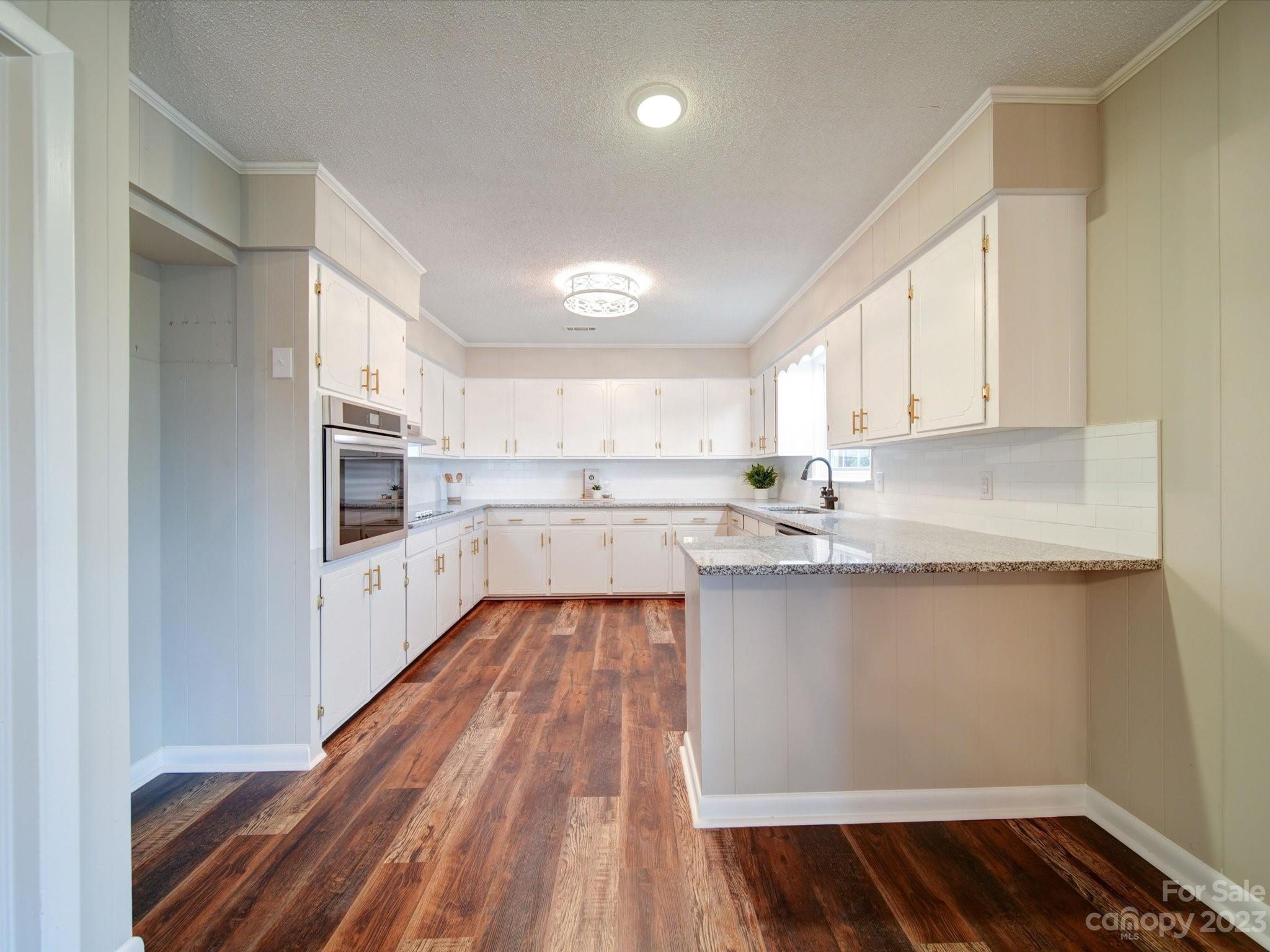 893 State Rd S-13-35 Pageland, SC 29728 - Photo 12 of 25 a kitchen with granite countertop white cabinets and white appliances