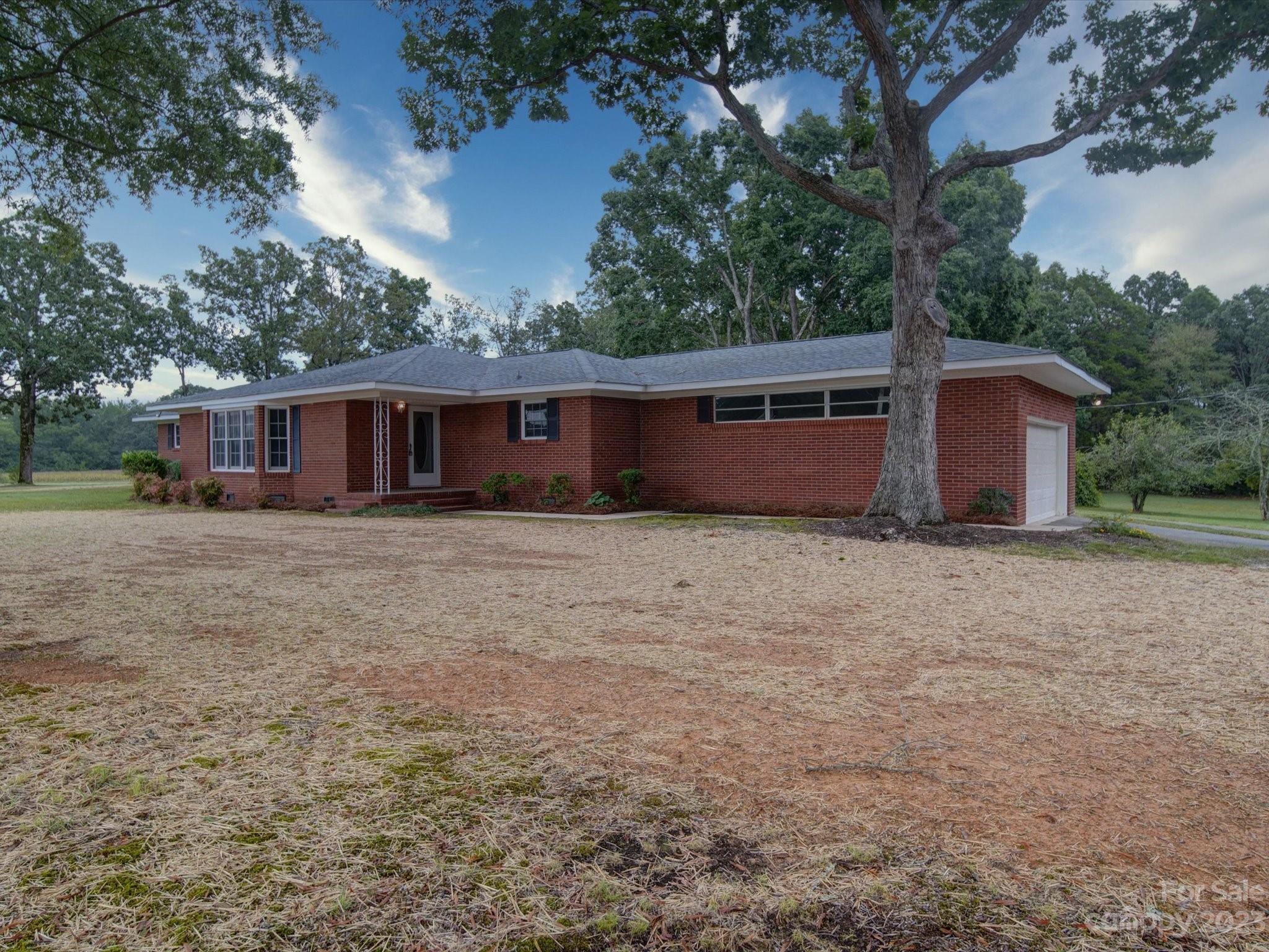 893 State Rd S-13-35 Pageland, SC 29728 - Photo 2 of 25 a front view of house with yard and trees in the background