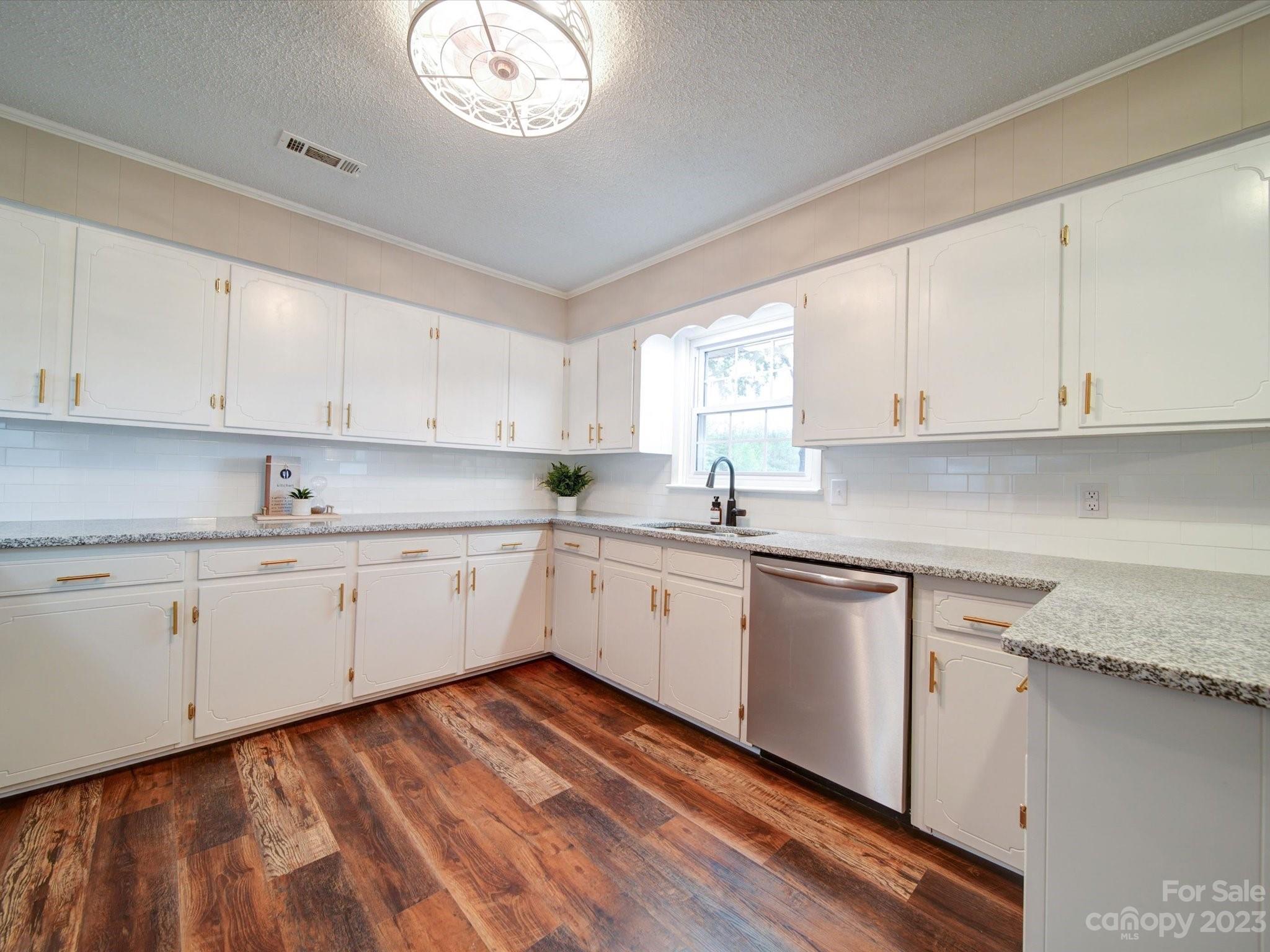893 State Rd S-13-35 Pageland, SC 29728 - Photo 8 of 25 a kitchen with granite countertop white cabinets white stainless steel appliances and a window
