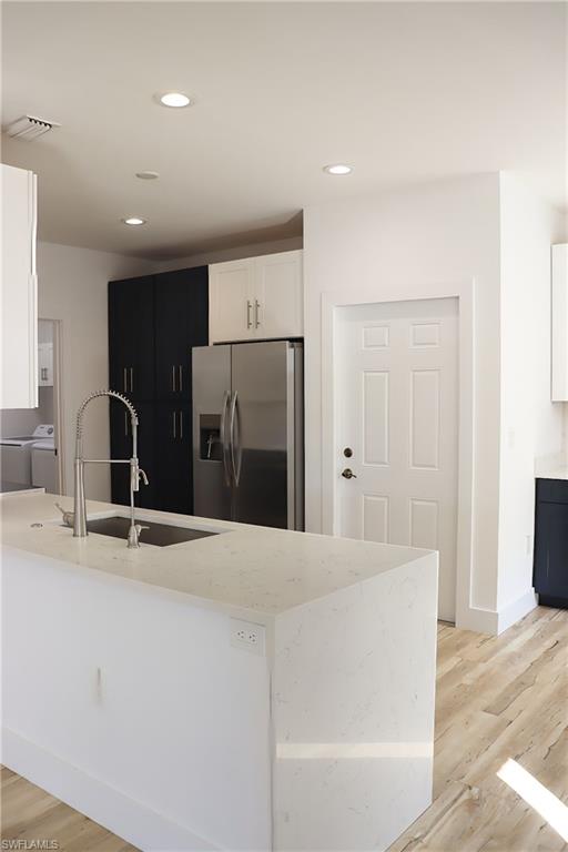 15489 Summit Pl Circle, Unit 302 Naples, FL 34119 - Photo 2 of 25 Kitchen featuring a quartz waterfall edge.