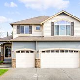 a front view of a house with a garage