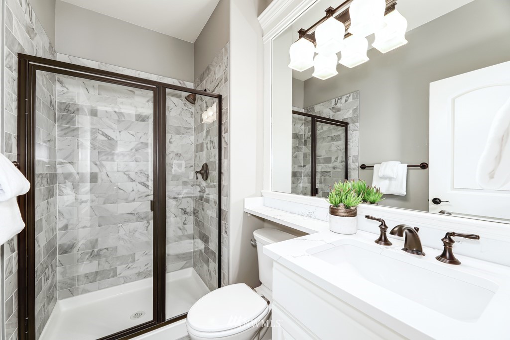 21303 37th Avenue Southeast Bothell, WA 98021 - Photo 12 of 34 a bathroom with a sink a toilet and a mirror