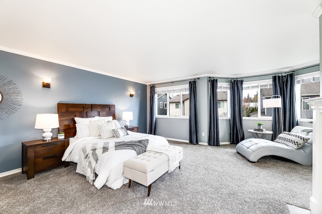 21303 37th Avenue Southeast Bothell, WA 98021 - Photo 15 of 34 a bedroom with a bed couch and a large window